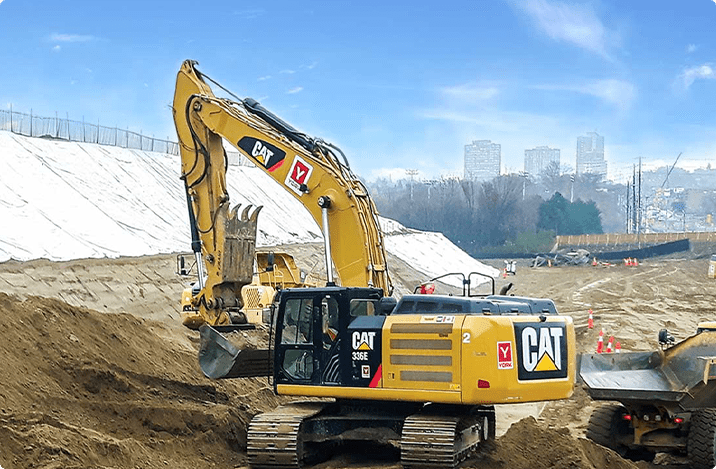 Yellow York1 excavator on a job site moving dirt
