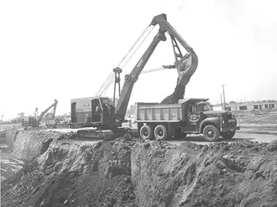 Black and white shot of machinery on a job site in 1950
