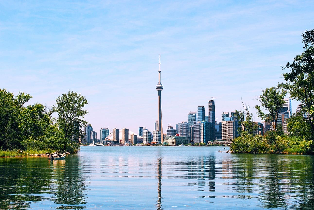 Wideshot of Toronto skyline taken from Toronto Island. Lake and greenery in foreground, CN tower as the focal point.