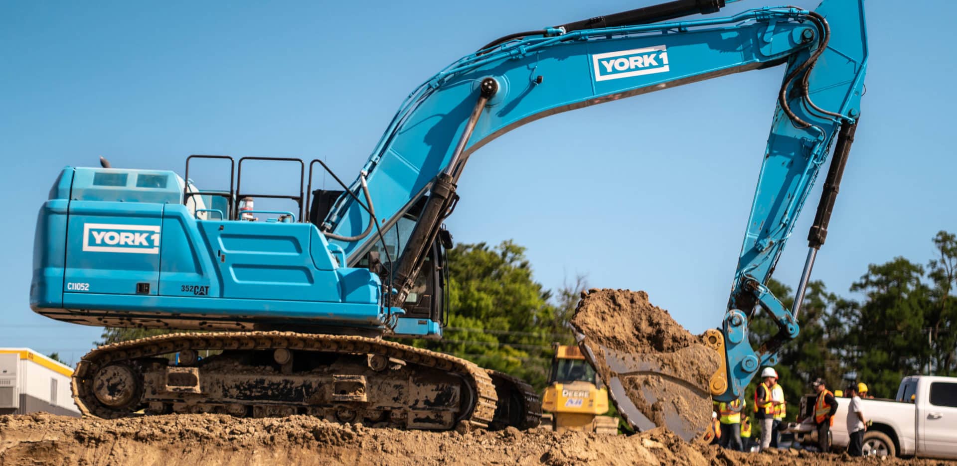 A York1 excavator with a bucket of soil