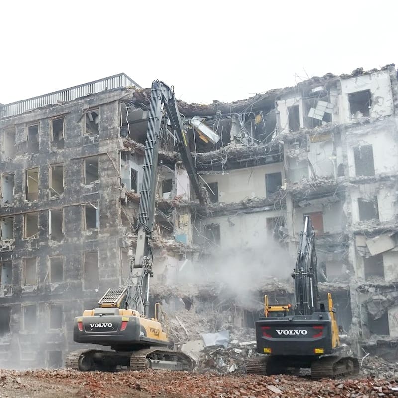 Two excavators demolish the former, multi-storey Hotel D'eau hospital in St. Catharines, Ontario