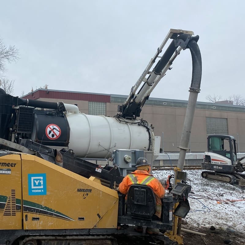 Directional Drilling machine and operator working on the Metrolinx project in the winter