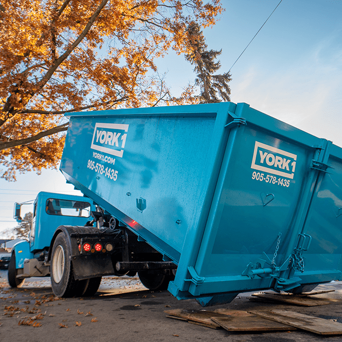 York1 dumpster bin being delivered to a residential house.