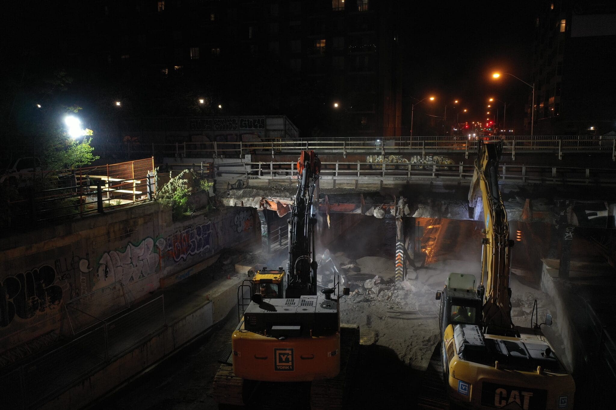 Night shot of 2 YORK1 excavators demolishing an urban bridge