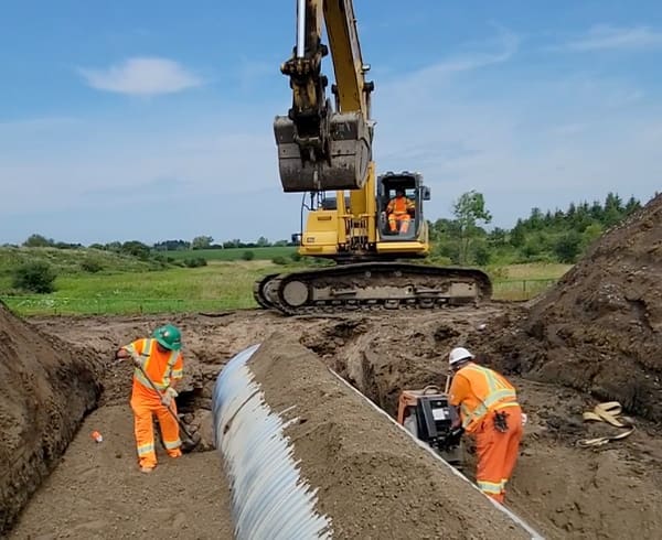 Workers installing a stormwater main for civil and site construction project services.