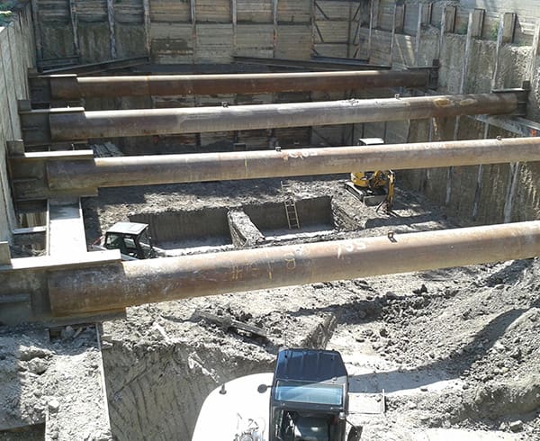 Underpinning at a construction site used to strengthen and stabilize an existing foundation.