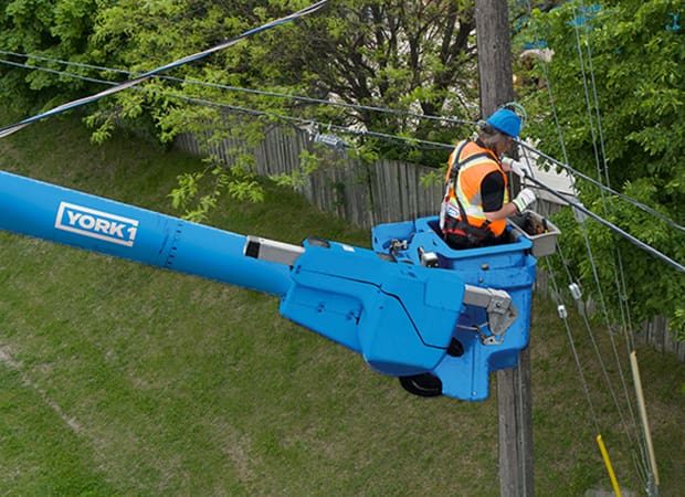 Aerial Utility Services Blue Bucket Truck with Utility Worker