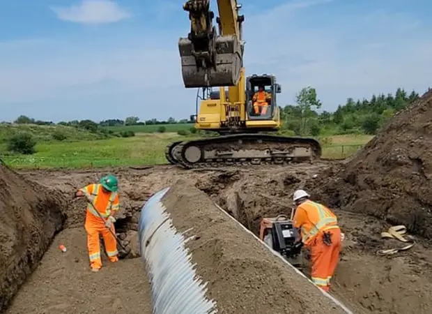 Large corrugated steel pipe in a trench