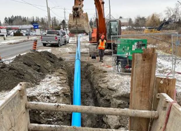 Watermain Installation Project Large blue watermain pipe with trench boxes
