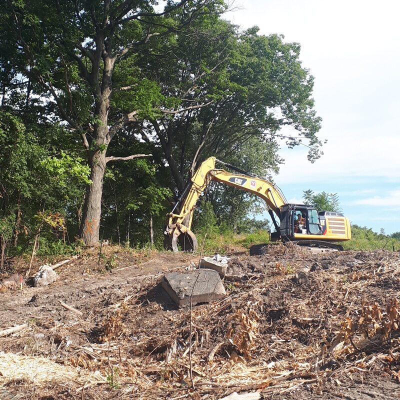2207104_York1_NW_VicPark An excavator on top of a mountain of dirt and tree roots at the former Victoria Park landfill.