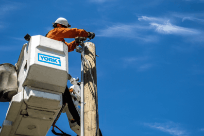 An employee of performing aerial utility work at height